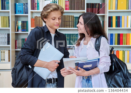 Portrait of two teenage students classmates boy and girl talking at school Portrait of two teenage students classmates boy and girl talking at school 136404434