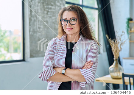 Portrait of middle-aged confident business woman looking at camera Portrait of middle-aged confident business woman looking at camera 136404446