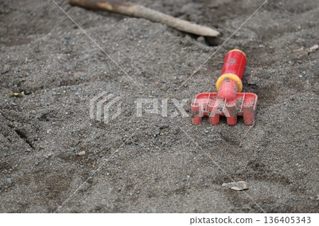 A rake left in the sandbox A rake left in the sandbox 136405343