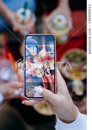 Smartphone capturing picnic takeaway bowls and drinks for social media Smartphone capturing picnic takeaway bowls and drinks for social media 136406011