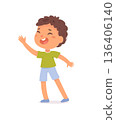 Smiling cartoon boy with curly brown hair, wearing green t-shirt, blue shorts, and slippers, waving hand. Happy child character illustration on white background. Cartoon vector illustration 136406140