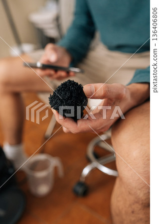 Person holding used steam cleaner scrub brush. Concept of maintenance aspect of household appliances and requirement for replacing parts to ensure effective and hygienic cleaning tasks. 136406806