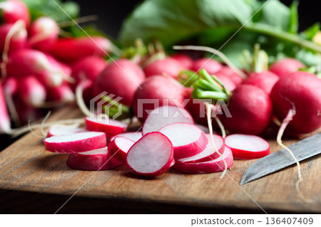Close up of fresh radishes with leafy tops Close up of fresh radishes with leafy tops 136407409