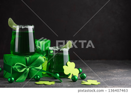 Green Cocktails with Shamrocks and Gifts. Festive St. Patricks Day Celebration Still Life Green Cocktails with Shamrocks and Gifts. Festive St. Patricks Day Celebration Still Life 136407463
