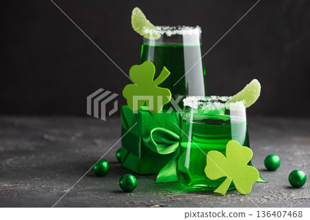 Green Cocktails with Shamrocks and Gifts. Festive St. Patricks Day Celebration Still Life Green Cocktails with Shamrocks and Gifts. Festive St. Patricks Day Celebration Still Life 136407468