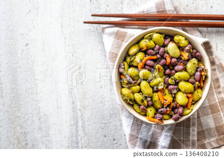 Fresh salad with edamame beans in bowl on checkered napkin. Top view. Fresh salad with edamame beans in bowl on checkered napkin. Top view. 136408210