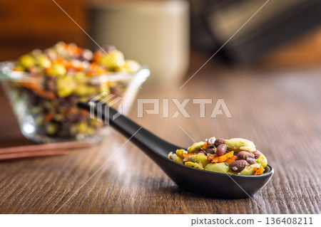 Fresh salad with edamame beans in ceramic spoon on wooden table. Fresh salad with edamame beans in ceramic spoon on wooden table. 136408211