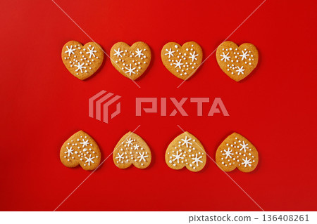 beautiful hand-baked cookies in the shape of a heart on a red background beautiful hand-baked cookies in the shape of a heart on a red background 136408261