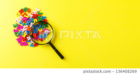 colored letters of the alphabet with a magnifying glass on a yellow background colored letters of the alphabet with a magnifying glass on a yellow background 136408269