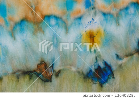 abstract pattern on silk fabric texture in blue, yellow, green colors 136408283