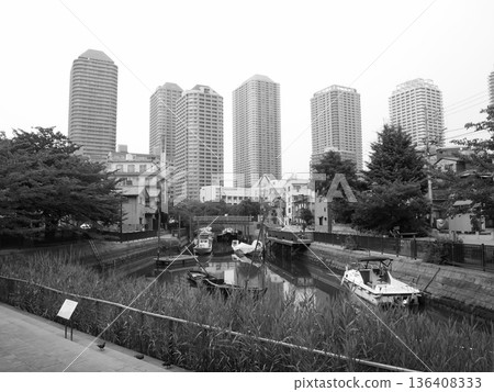 Tsukudajima's downtown atmosphere intersects with modern buildings in this urban landscape Tsukudajima's downtown atmosphere intersects with modern buildings in this urban landscape 136408333