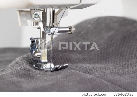 Sewing machine, stitching fabrics, needle in a round plan 136408353