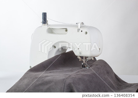 Sewing machine, stitching fabrics, needle in a round plan Sewing machine, stitching fabrics, needle in a round plan 136408354