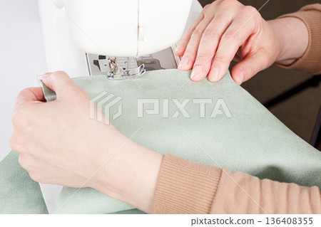 Sewing machine, stitching fabrics, needle in a round plan 136408355