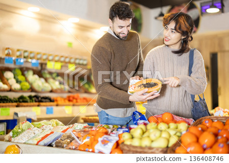 Married couple choose papaya together at grocery supermarket 136408746