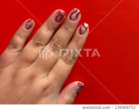 Festive red and silver manicure with ribbon nail art Festive red and silver manicure with ribbon nail art 136408752