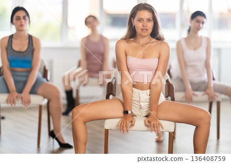 Sitting on chair, girl train to perform lap dance, interacting with imaginary partner Sitting on chair, girl train to perform lap dance, interacting with imaginary partner 136408759
