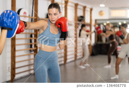 Young women in gym boxing training Young women in gym boxing training 136408778
