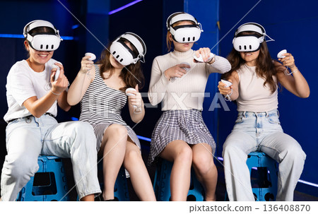 Girls using virtual reality glasses - girlfriends having fun with vr headset 136408870
