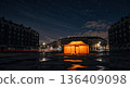 Illuminated orange tent in city square at night under starry sky. Urban emergency shelter or event marquee, blackout 136409098