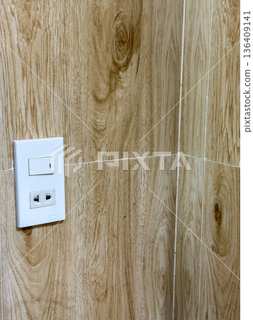 Electrical wall outlet on wooden tile wall Electrical wall outlet on wooden tile wall 136409141