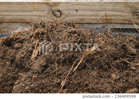 Close-up horizontal shot of compost prepared for sustainable fertilisation in gardens and farms Close-up horizontal shot of compost prepared for sustainable fertilisation in gardens and farms 136409599