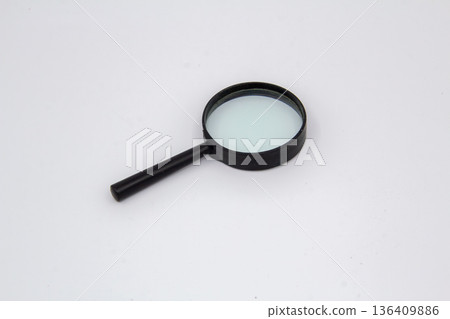 A magniifuing loupe is a handy tool for reading small letters A magniifuing loupe is a handy tool for reading small letters 136409886