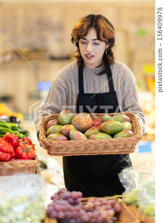 Eco food vegetable market, girl worker and mango. 136409978