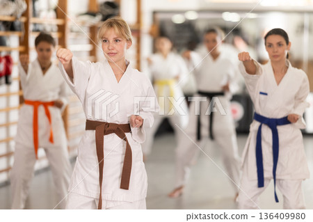Young women during group karate training 136409980
