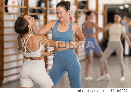 Young women in self-defense training Young women in self-defense training 136409982