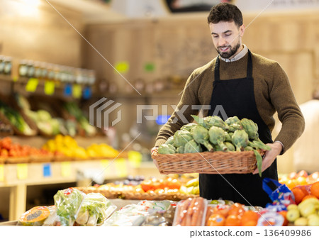 Eco food vegetable market, male worker and artichoke 136409986