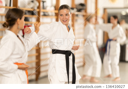 Women train to perform defensive karate installations and attacking combat techniques 136410027