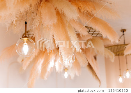 Pampas grass decor and pendant lights in modern dining interior Pampas grass decor and pendant lights in modern dining interior 136410330