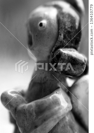 clay figurine in the shape of an angel praying 136410779