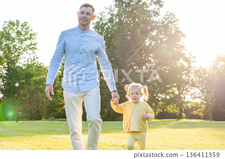 Dad daughter. Dad running with little daughter at sunset. 136411359