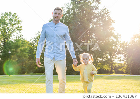 Park playtime. Father and toddler enjoying summer nature. 136411367