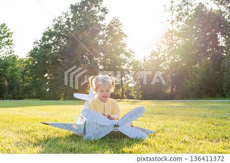 Flying girl. Yellow cardboard costume child. Park activity sunshine toddler. 136411372