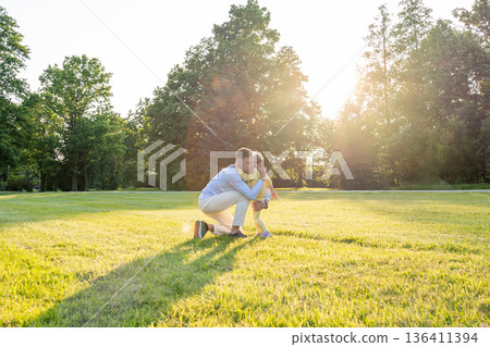 Father child. Dad and daughter playful moment in park. Father child. Dad and daughter playful moment in park. 136411394