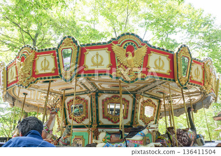 A colorfully decorated carousel at an amusement park 136411504
