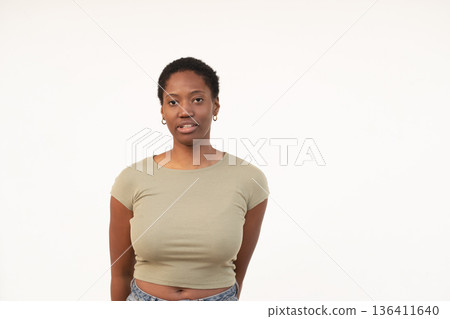 Young woman with short Afro hair against white Young woman with short Afro hair against white 136411640