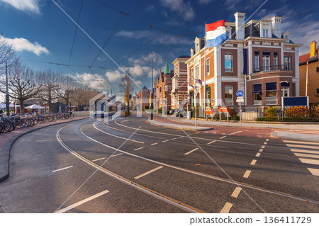 Tram Passing Historic Building in Amsterdam, Netherlands 136411729