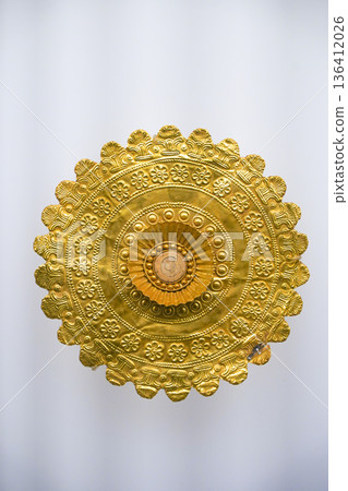 Isolated Ancient Round Gold Jewelry Artifact on White Background. High quality photo 136412026