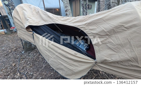 Hammock tent in the forest, exterior and tarp setup Hammock tent in the forest, exterior and tarp setup 136412157
