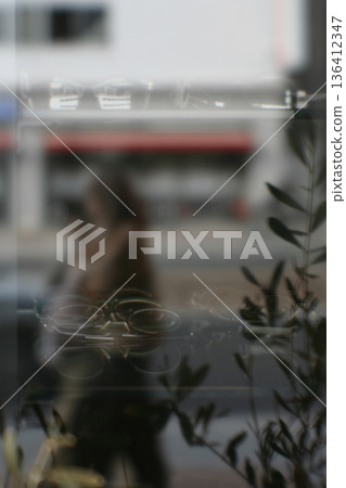 Glasses shop window and female pedestrian (soft focus) Glasses shop window and female pedestrian (soft focus) 136412347