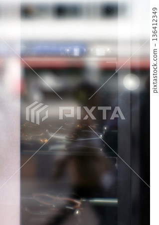 Glasses shop window and female pedestrian (soft focus) 136412349