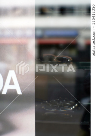Optician shop window and pedestrians (soft focus) Optician shop window and pedestrians (soft focus) 136412350