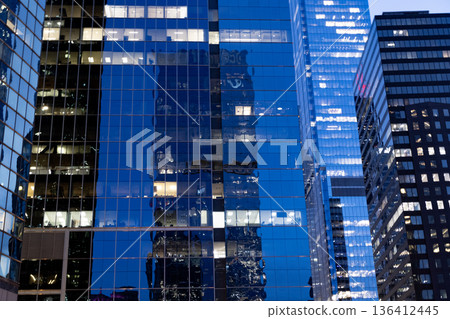 Building architecture at night. Building background. Glass building window. Architectural detail. Background of architecture. Modern glass background. Glass background. Modern backdrop. Architecture Building architecture at night. Building background. Glass building window. Architectural detail. Background of architecture. Modern glass background. Glass background. Modern backdrop. Architecture 136412445