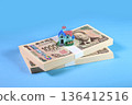 A stack of bills and a miniature house 136412516