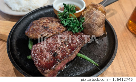 Assorted steak and hamburger set meal served on a hot plate Assorted steak and hamburger set meal served on a hot plate 136412746