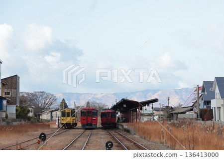 A JR Toyohashi Main Line train stops at Miyaji Station with the Aso Mountains in the background. A JR Toyohashi Main Line train stops at Miyaji Station with the Aso Mountains in the background. 136413000